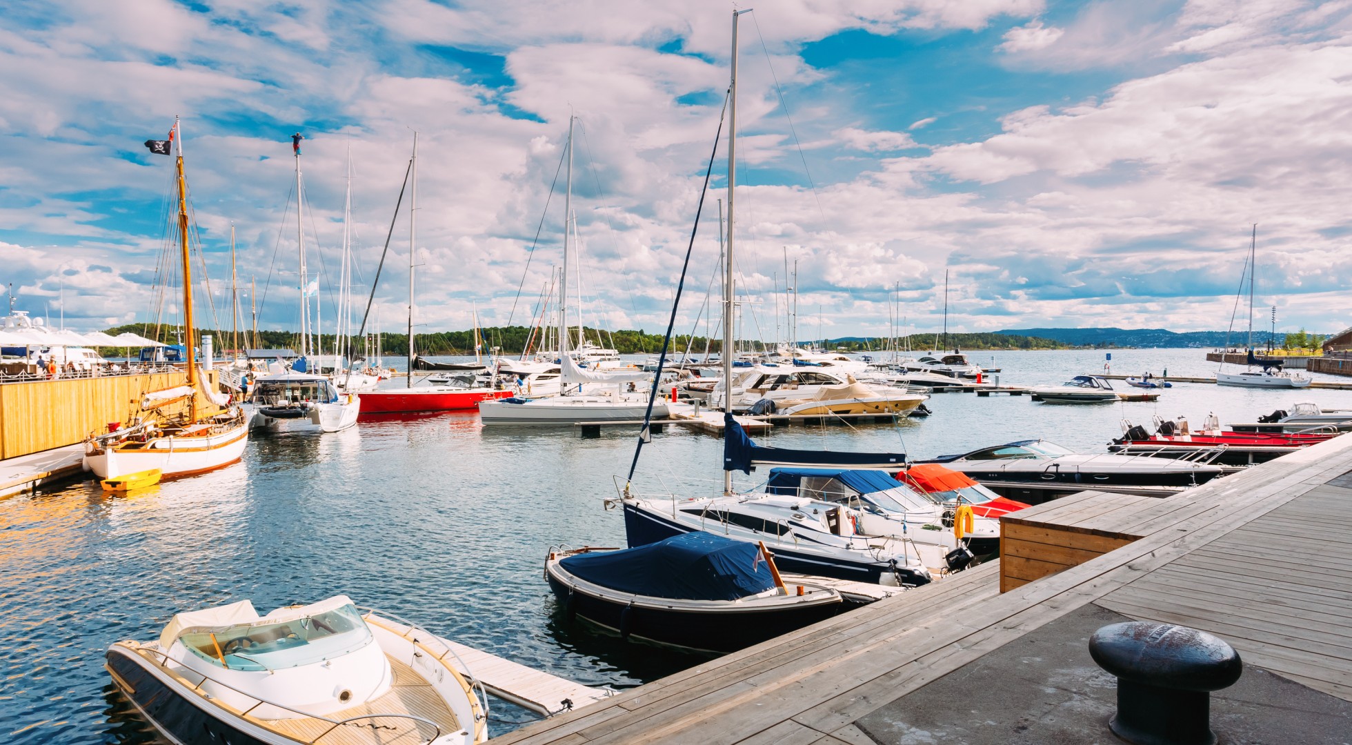 Yachts moored at town quay in district Aker Brygge, Oslo, Norway