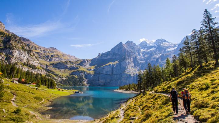 Tourist in summer view over the Oeschinensee (Oeschinen lake)