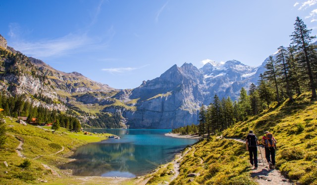 Tourist in summer view over the Oeschinensee (Oeschinen lake)